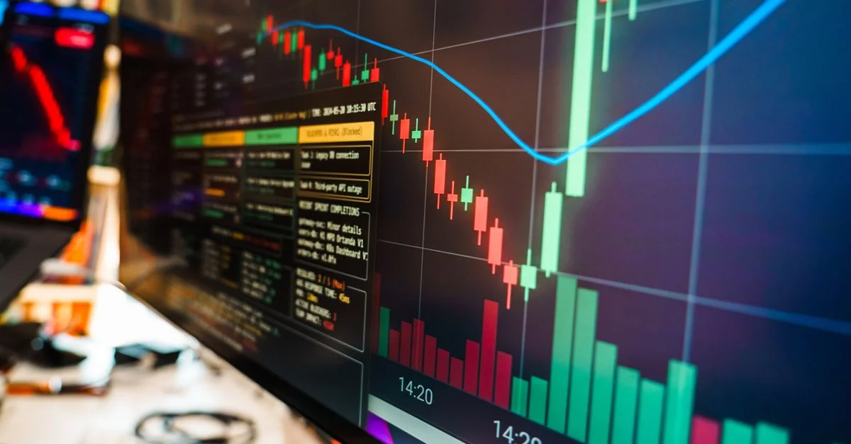 Gros plan sur un écran financier affichant des données et des graphiques en temps réel sur les cryptomonnaies dans un bureau moderne.